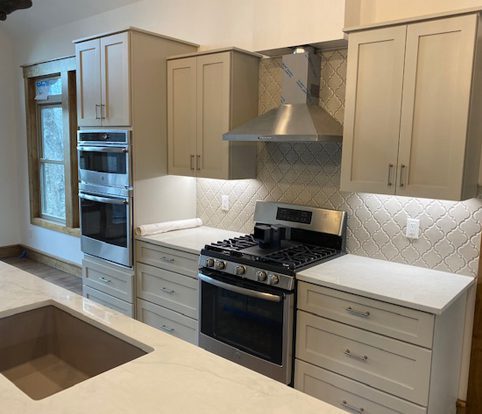 Rice Furniture & Design Center | wood cabinets custom designed for a kitchen with a tiled backsplash and under cabinet lighting Rice Furniture & Design Center | wood cabinets custom designed for a kitchen with a tiled backsplash and under cabinet lighting